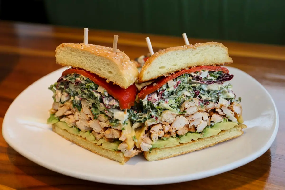CHICKEN & AVOCADO SANDWICH with roasted red pepper and greens with cayenne aioli + wild rice