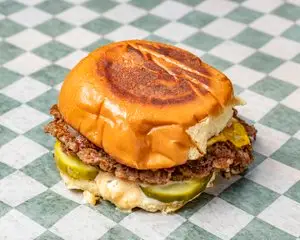 Double impossible  Burger, vegetarian. Double Impossible patty served with American cheese, grilled onions, pickles and house sauce on a Martin's potato bun 