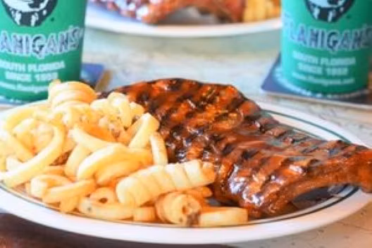 Award Winning Baby Back Ribs 1/2 Rack drenched with our special B B Q sauce with fries and a beer.