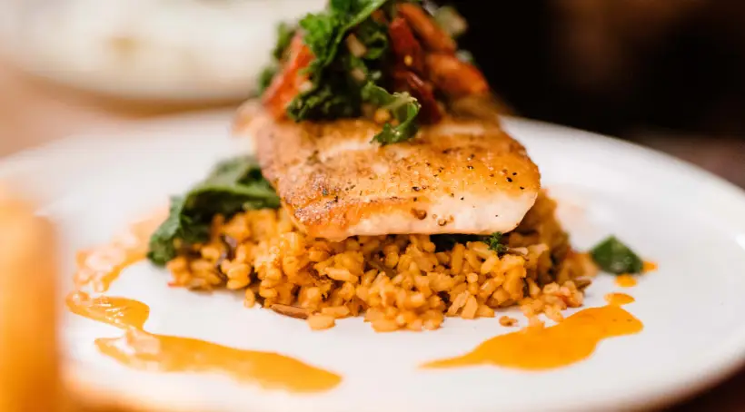 Chipotle Honey Salmon with sweet potato, elotes, snap pea, pepitas, lime crema